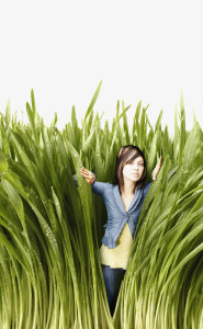 Young woman pushing back tall grass